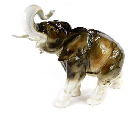 A Royal Dux porcelain figure, modelled as an elephant with raised trunk, printed marks, 33cm high. 