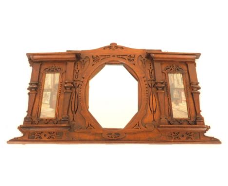 An Edwardian overmantel mirror, of architectural design with flat pilasters and fret cut decoration incorporating an octagona