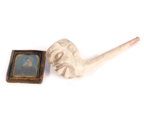 A 19thC clay pipe, modelled the head of a black man, bears registration lozenge, 19cm wide, together with a Victorian daguerr