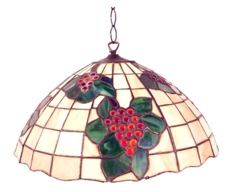 A 20thC Tiffany style light shade, of cylindrical tapering form decorated with bunches of grapes, leaves, etc., against on of