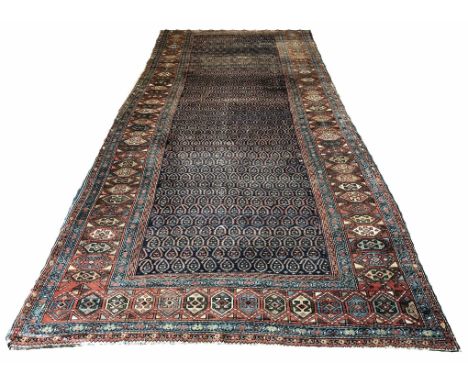 NORTH WEST PERSIAN CORRIDOR CARPET, 485cm x 206cm, field of boteh guls within multiple geometric bands and borders.