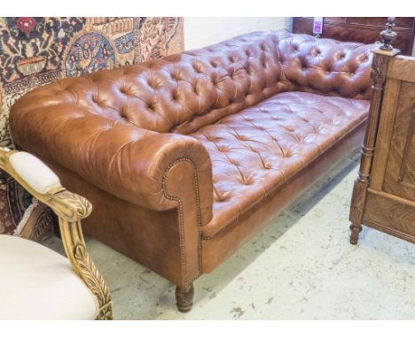 CHESTERFIELD SOFA, with buttoned tan leather upholstery and studded decoration, on front turned supports, 66cm H x 209cm W x 