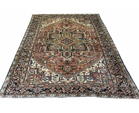 ANTIQUE HERIZ CARPET, 318cm x 240cm, central medallion on a terracotta palmette and vine field within corresponding spandrels