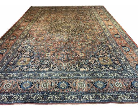 ANTIQUE TABRIZ CARPET, 545cm x 388cm, central medallion on a palmette and vine terracotta field within complimentary spandrel