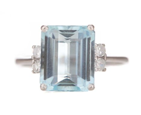 AQUAMARINE AND DIAMOND RING set with step cut aquamarine flanked by diamonds, marked 18K, size P3.8gLightly worn.&nbsp;Stone 