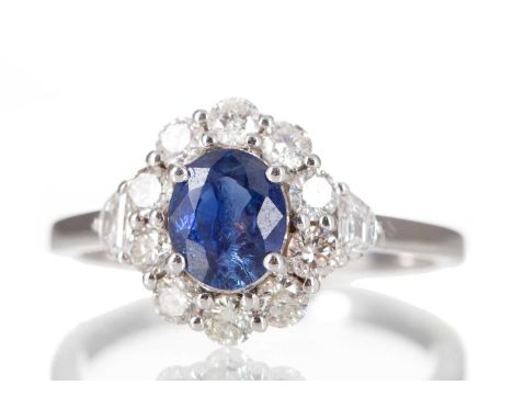 SAPPHIRE AND DIAMOND CLUSTER RING set with an oval sapphire of approximately 0.83 carats, within a halo of round brilliant cu