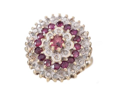 LARGE RUBY AND DIAMOND CLUSTER RING set with round and oval rubies and illusion set with diamonds, in nine carat gold, dated 