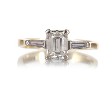 DIAMOND DRESS RING the emerald cut diamond of approximately 1.40 carats, flanked by tapered baguette cut diamonds totalling a