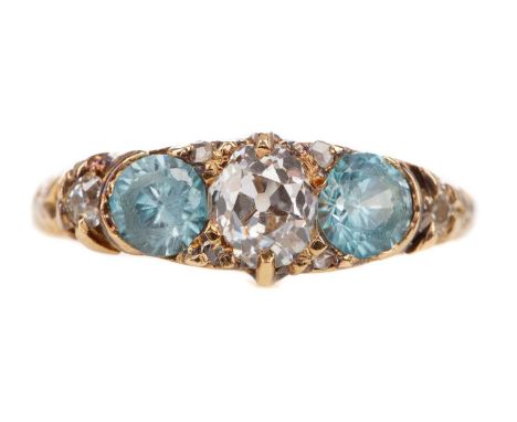 BLUE GEM SET AND DIAMOND RING set with a central old mine cut diamond flanked by blue zircon and smaller diamonds, in eightee