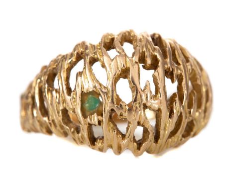 DRESS RING EIGHTEEN CARAT GOLD of openwork bombe form, with small emerald glued into one of the spaces, size O6.6gGenerally w