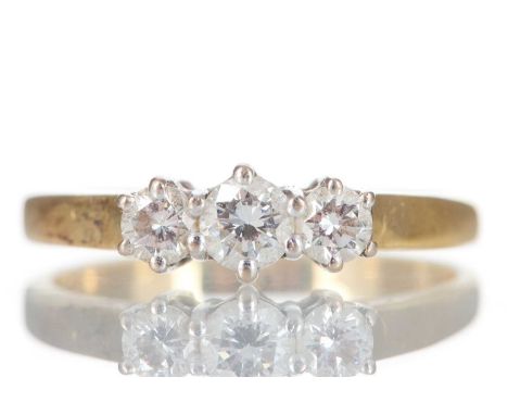 DIAMOND THREE STONE RING set with round brilliant cut diamonds totalling approximately 0.45 carats, in eighteen carat gold, s