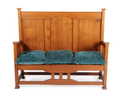 An Arts &amp; Crafts Oak Hall Bench/Settle, with capped uprights and feet, panelled back and slatted sides, solid pine base, 