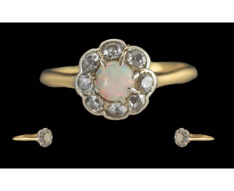 Ladies Pleasing Petite 18ct Gold Opal and Diamond Set Cluster Ring. Marked 18ct to Shank. The Central Opal of Pleasing Colour