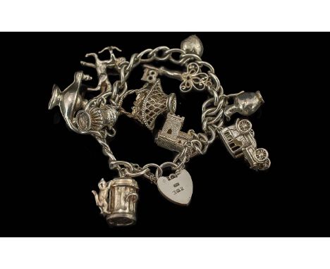 A Fine Vintage Sterling Silver Charm Bracelet Loaded with 10 Silver Charms. Both Bracelet and Charms Marked for Silver. Vario