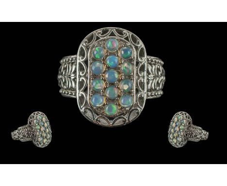 Attractive Opal Cluster Ring with three rows of round cut, cabochon opals, with a good display of colours, set in a decorativ