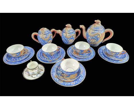 A Blue Porcelain Japanese ''Dragonware'' Tea Service with Geisha girl to base of cups. Comprises two teapots, lidded sugar bo
