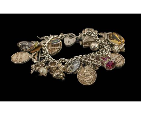 Fine Sterling Silver Vintage Charm Bracelet loaded with approx.23 silver charms, with full silver hallmarks; various and inte
