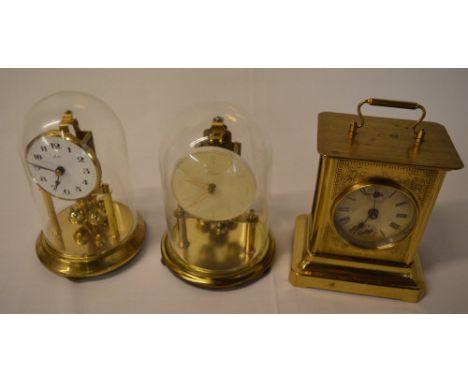 2 anniversary clocks under domes and a carriage clock