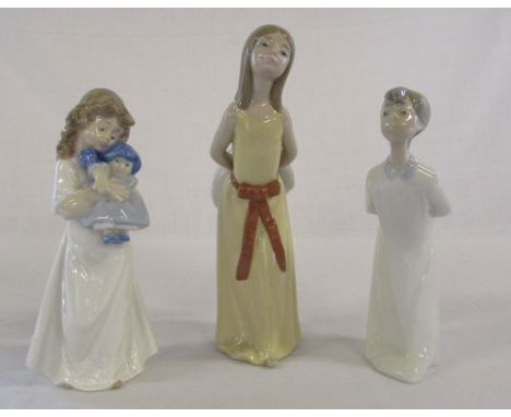 Lladro figure of a girl in a yellow dress 5006, young boy in a white gown & a Nao figure of a young girl with a doll 1107