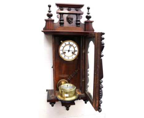 A late 19th century mahogany eight-day German wall clock with Roman numerals, together with a brass ship's barometer.
