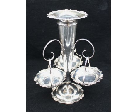 A George V silver epergne centrepiece, consisting of central large trumpet shaped flower vase, with three elaborate scrolled 