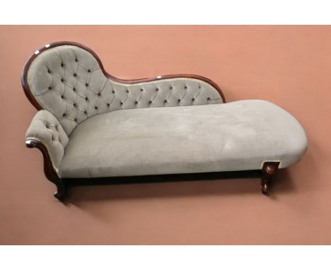 A late Victorian chaise lounge, button back with green fabric, in mahogany.