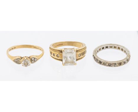 A collection of three stone set rings including a 14ct gold ring set with a rectangular scissor cut cz, size L1/2, along with