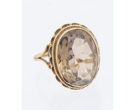 A vintage smoky quartz and 9ct gold oval dress ring, set with an oval mixed cut quartz within rope border, width approx 2mm, 