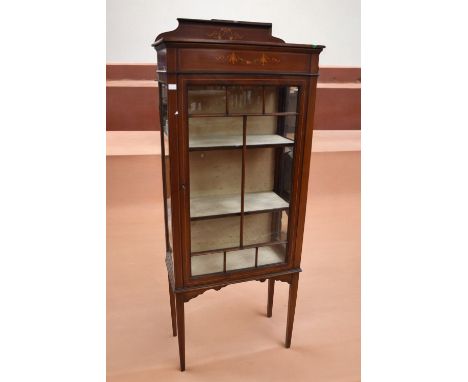 An Edwardian two shelf glazed display cabinet with ornate detail, one cracked pane