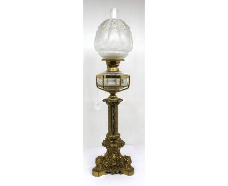 A large ornate late 19th / early 20th century Gothic style oil lamp, with mounted glass front, flume and shade, approx. 82.5c