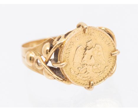A yellow metal mounted coin ring, comprising a Mexican 2.5 pesos 1920-1940 bullion issue coin, width approx 12mm, fancy decor