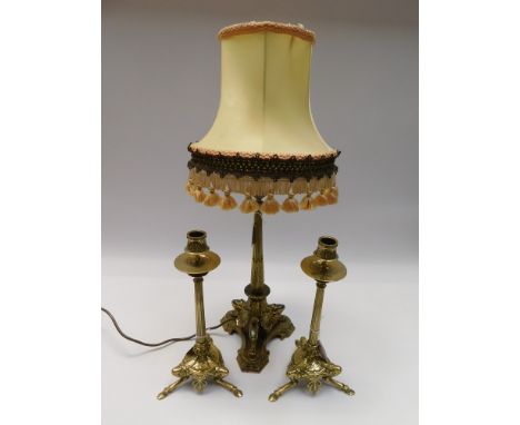 A pair of 20th century reproduction brass three legged candlesticks of ornate Victorian style, along with similar three legge