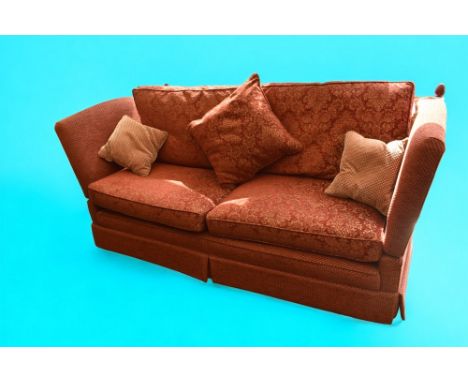 Large high-backed deep red Knole sofa with drop sides and ties, together with single matching sofa chair.