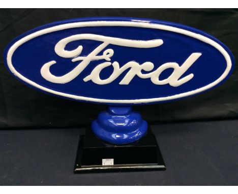 A 20th century painted metal Ford car sign, raised on rectangular wooden base; 50cm wide