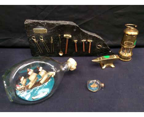 Miniature Blacksmith's tools on slate display, miniature anvil, Investiture Prince of Wales 1969 miners lamp and two ships in