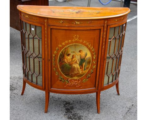 An 18th Century Style Sheraton Revival satinwood demi-lune commode, circa 1890, the top painted with urn of flowers with pear