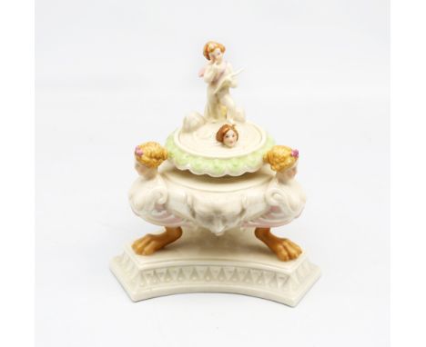A Royal Worcester late 19th century glazed Parian Ariosto inkwell, the circular bowl supported by three caryatids on paw feet