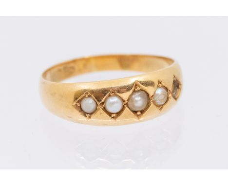 A seed pearl 18ct gold ring, width approx 6mm, size Q, total gross weight approx 3.6gms   Further details: one pearl deficien