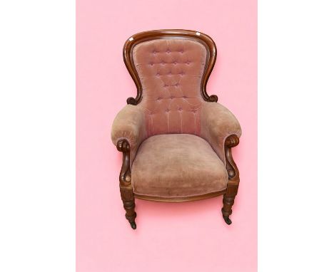 A late 19th Century button back mahogany parlour armchair on castors.