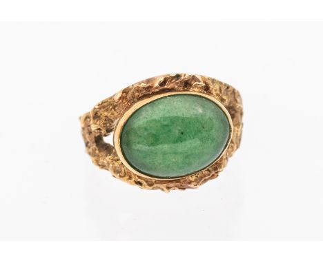Richard Bonehill: a jadeite set 9ct gold ring, set with an oval cabochon jadeite approx 10x13mm, to a textured gold band, siz