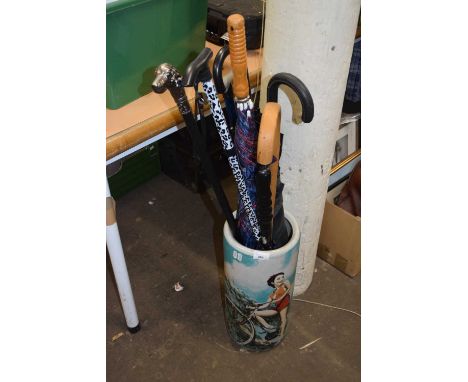 Modern ceramic stick stand with various walking sticks and umbrellas