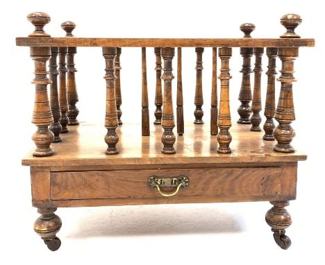 Victorian walnut two division Canterbury, spindle uprights, single frieze drawer, raised on turned supports with brass and ce