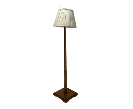 Early 20th century Art Deco walnut standard lamp, square tapered upright on a moulded square base, together with a later shad