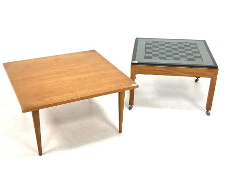 Mid to Late 20th century teak games table, the inset granite and slate top raised on square supports and castors (61cm x 61cm