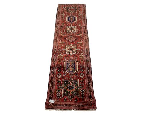 Persian karajeh red ground runner rug with repeating geometric medallions 70cm x 256cm