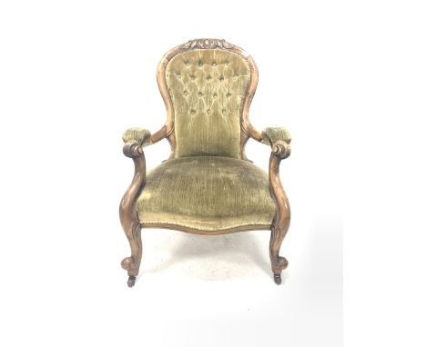 Victorian walnut open armchair, with floral carved crest rail over button upholstered back rest, scrolled arm terminals, rais