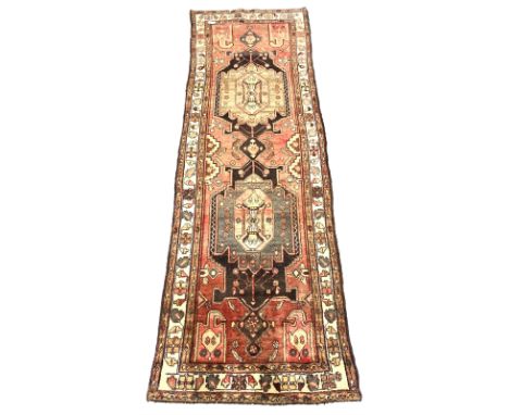 Vintage Persian red ground runner rug, geometric pole medallion enclosed by border decorated with geometric foliate 326cm x 1