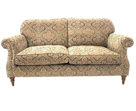 Parker Knoll three seat sofa, with squab cushions, upholstered in floral fabric, raised on turned front supports W194cm H