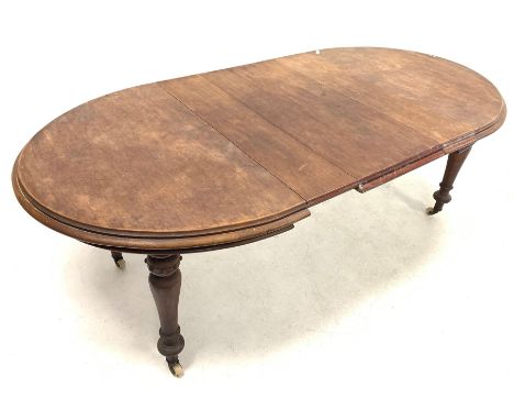 Victorian mahogany wind out extending dining table, the oval top with moulded edge, raised on turned supports with brass and 