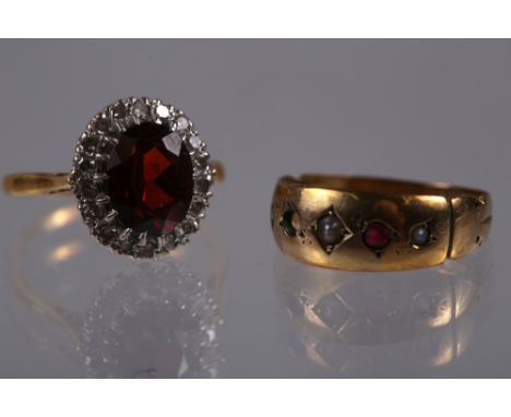 An 18ct gold, diamond and ruby cluster ring, size J, 3.8g, and a 9ct gold ruby and seed pearl dress ring (one stone missing),